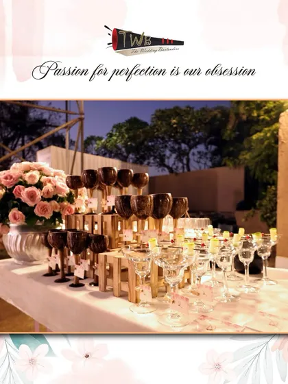 An elegant display of glassware for a Sangeet, including unique dark-hued wine glasses, ready for our signature mocktails.