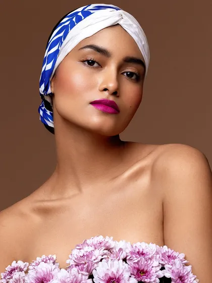 A high-fashion beauty shoot where I used a printed scarf as a head wrap and fresh flowers to create a bold, artistic look.