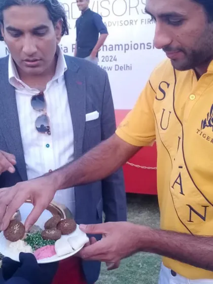 Presenting a plate of our Mediterranean appetizers to Maharaja Sawai Padmanabh Singh. Even in a casual outdoor setting, our presentation and quality remain paramount.