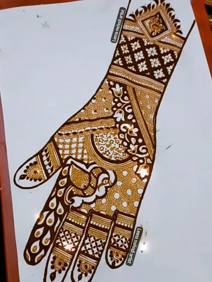 An intricate practice design featuring a large peacock on the palm. The wrist is adorned with a geometric pattern and a smaller peacock motif.