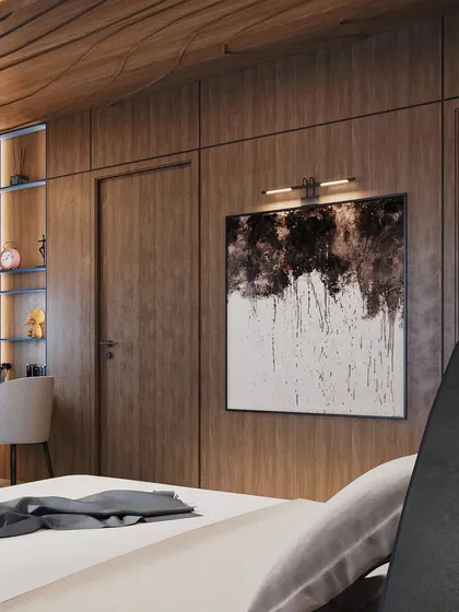 On the opposite wall, wood paneling adds warmth and texture. A large piece of abstract art is highlighted by a picture light, creating a focal point.