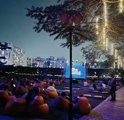 As dusk settles over Pune, the fairy lights in the trees begin to glow, setting the stage for a magical movie night at the Radisson Blu.