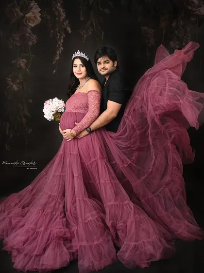 A majestic couple's portrait with a flowing gown. The fabric toss adds a sense of drama and movement, making the mom-to-be look like a queen.