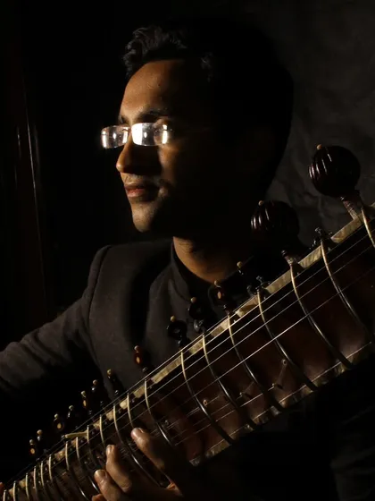 A low-key portrait with dramatic lighting, focusing on the connection between me and my instrument.