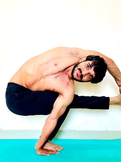 A standing balance that is a variation of Bird of Paradise, requiring open hips and a strong standing leg.