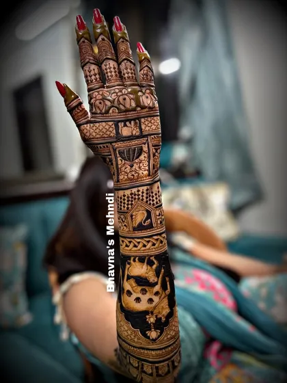 A full view of a stunning bridal back hand design. The arm is covered in intricate details, including a large portrait of a cow and calf.