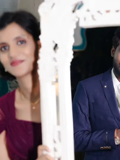 A creative shot using a mirror to frame the couple. The bride is in a beautiful gown, and the setting is perfect for a modern, artistic pre-wedding album.