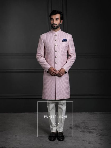 In the gentle charm of pink silk, tradition takes form. A sherwani with a straight silhouette and diamond jacquard artistry, crafted as a masterpiece of timeless grace.