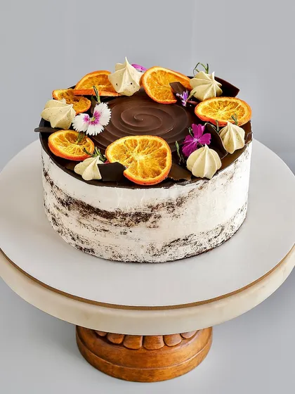(Hero Media) This Chocolate Orange Naked Cake is one of my absolute favorites to make. It features a soft chocolate sponge, a rich orange-infused dark chocolate ganache, and just a light touch of whipped cream. The candied oranges and fresh flowers make it a beautiful centerpiece for any occasion.
