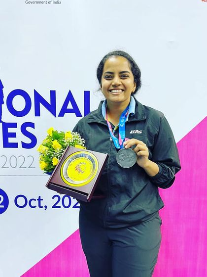 A solo shot of Kushi V with her silver medal and plaque from the 36th National Games. Her smile reflects the pride of a major national achievement.