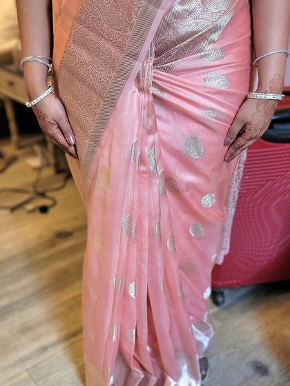 A close-up of the hip pleats on the soft silk saree. This technique gives a beautiful, fitted look around the waist.