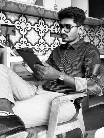 A black and white shot of me on-site, reviewing plans. The background shows a kitchen midway through its tile work.