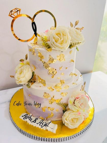 Love sealed with sweetness. A gorgeous two-tiered engagement cake with white roses and gold leaf.