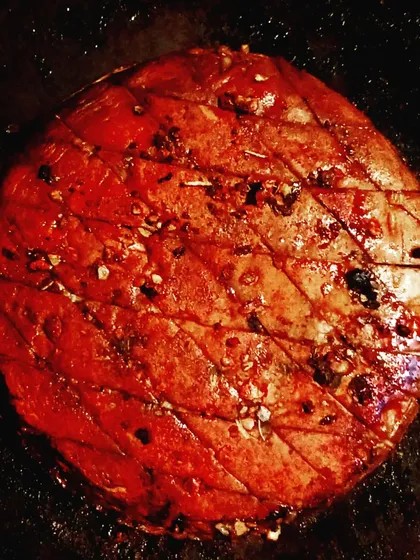 A close-up of the portobello mushroom steak before grilling. You can see the scoring on top which helps the marinade penetrate deeply and creates a beautiful texture when cooked.