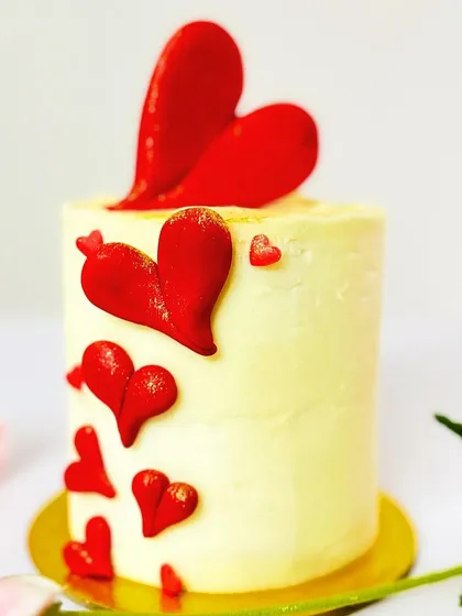 Introducing my Valentine's Day collection. This is an elegant, tall mini cake decorated with cascading edible red hearts. Perfect for a celebration for two.