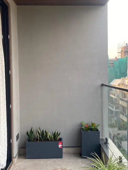Even a narrow section of a balcony can be beautified. Here, I've used sleek, rectangular planters with Snake Plants to add a touch of green without cluttering the space.