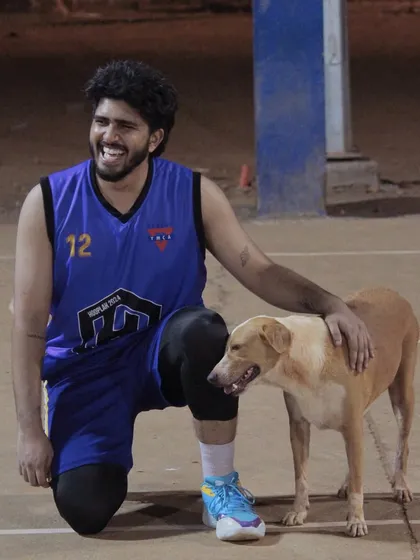 A player from The Underdawgs shares a moment with our court mascot. It shows the fun and friendly vibe of the team.