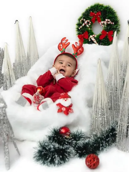 All smiles with his reindeer antlers on. I love when parents bring their own props, like these beautiful cones, which make the Christmas shoot even more unique and special.