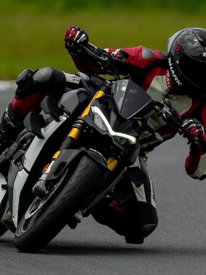 Another shot of the Ducati Streetfighter V4, showing the rider's body completely off the bike to maximize cornering speed.