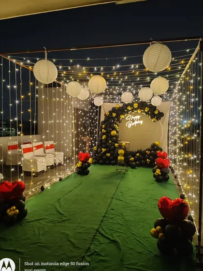 This photo captures the magical ambiance created by the fairy light canopy and paper lanterns. It's a popular choice for romantic proposals and anniversary dinners.
