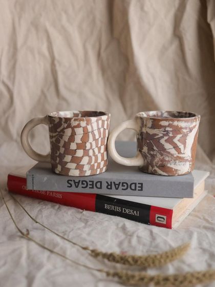 Both Nerikomi cups together. Though made as a pair, the unique patterns ensure that each one has its own distinct personality, just like everything made by hand.