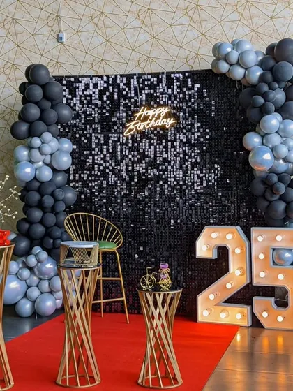 Our sequin backdrops add a touch of glamour to any event. This birthday setup combines a shimmering wall with marquee numbers and a balloon garland for a picture-perfect celebration.
