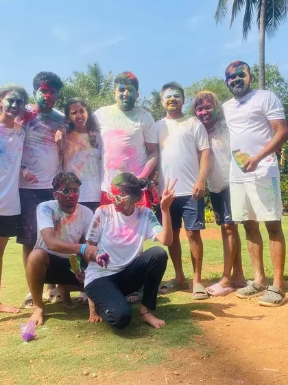A group of friends poses for a photo during our Holi event, showcasing the fun and festive spirit at Triquetra.
