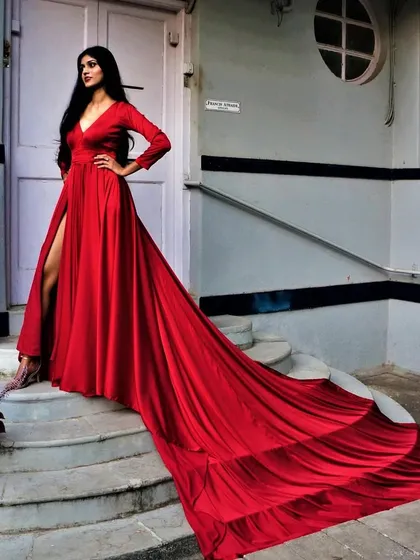 Be the sultry siren in our liquid silk gown. This red dress features a dramatic, extra-long trail and a thigh-high slit, designed to create stunning, high-impact photographs.