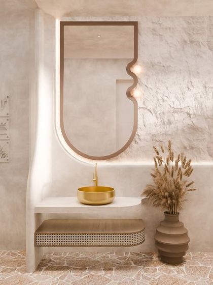 Inside the washroom, raw microcement textures embrace golden accents. The custom-shaped mirror and floating vanity continue the theme of organic curves, creating a space that feels both earthy and luxurious.