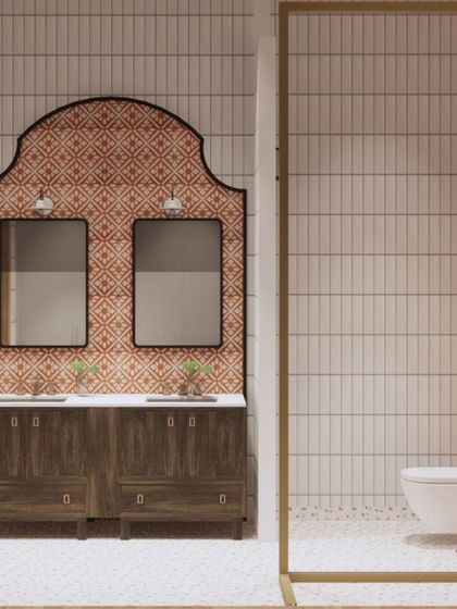 Inspired by traditional Goan design, this bathroom features a custom-shaped backsplash with terracotta-colored tiles. The dark wood vanity and simple white subway tiles create a look that is both rustic and refined.