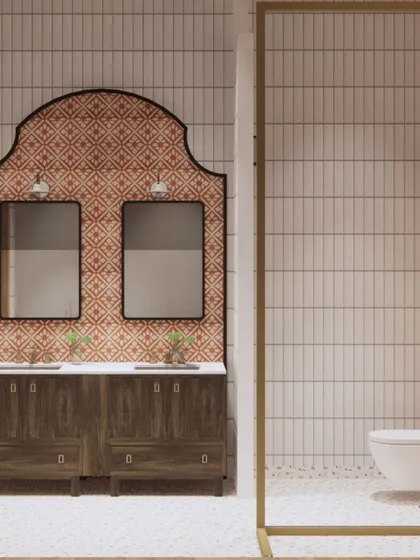 This bathroom design for the Goa project features a custom vanity with twin mirrors, set against a backdrop of vibrant, patterned terracotta-colored tiles. It's a nod to traditional Portuguese-Goan aesthetics with a modern twist.