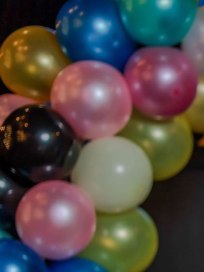 A vibrant cluster of multi-colored balloons from a party's decoration arch. These shots add a splash of color and fun to the final photo gallery.