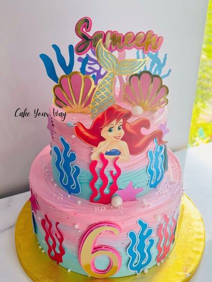 Mermaid wishes and starfish kisses on this two-tier under-the-sea cake for a 6th birthday.
