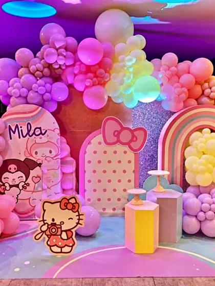 A dreamy Hello Kitty and friends themed birthday party for Mila. This pastel-colored setup features a large balloon arrangement, character cutouts, and a glittery backdrop.