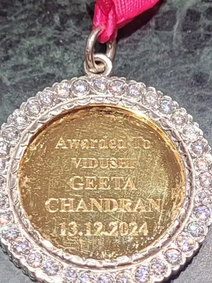 The beautiful gold medal I received with the Nritya Choodamani title from Krishna Gana Sabha, engraved with my name and the date. A truly precious memento.