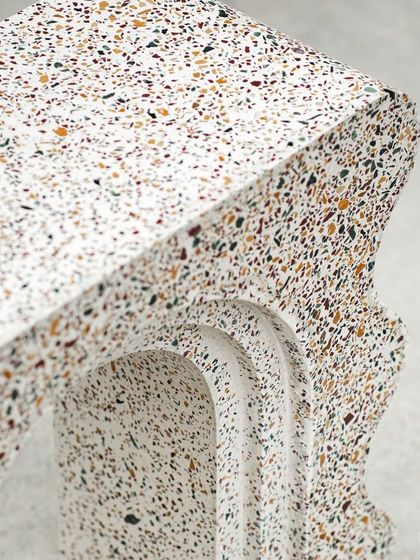 The intricate arch detail of our terrazzo bookshelf. This piece showcases our ability to cast complex shapes and forms while maintaining a flawless, high-quality finish.
