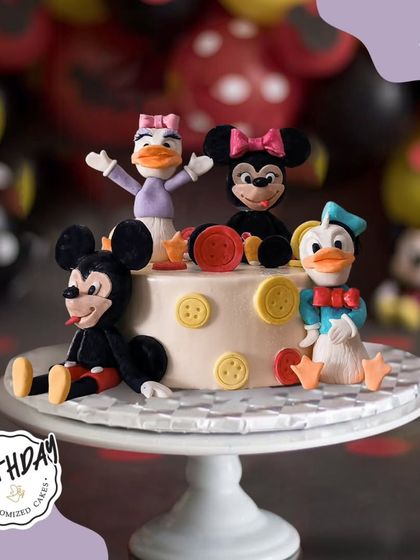 The whole Mickey Mouse clubhouse is here to party. This cake features Mickey, Minnie, Donald, and Daisy, all ready to celebrate a special birthday.