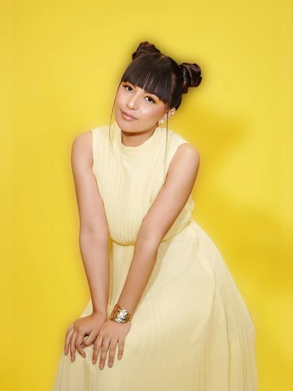 A sweet and sunny portrait of a model in a yellow dress, part of our campaign to bring you the best looks of the season.