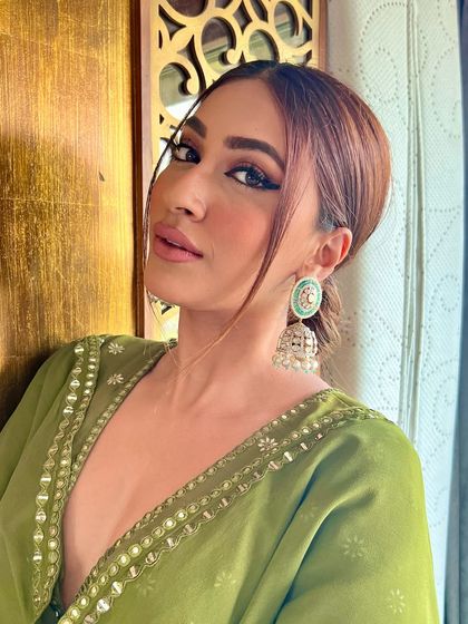 A full look at our statement mint green jhumkas, showcasing their intricate craftsmanship and how they beautifully complement a traditional outfit.