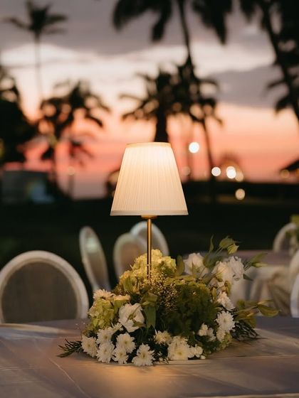 A table centerpiece with a lamp, set against the beautiful colors of the Goan sunset.