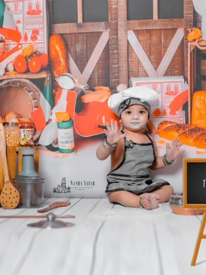 Welcome to the 'Little Chef's Kitchen'. This theme is all about fun and capturing candid moments as your baby plays with safe props like flour and toy food in a custom-designed kitchen backdrop.
