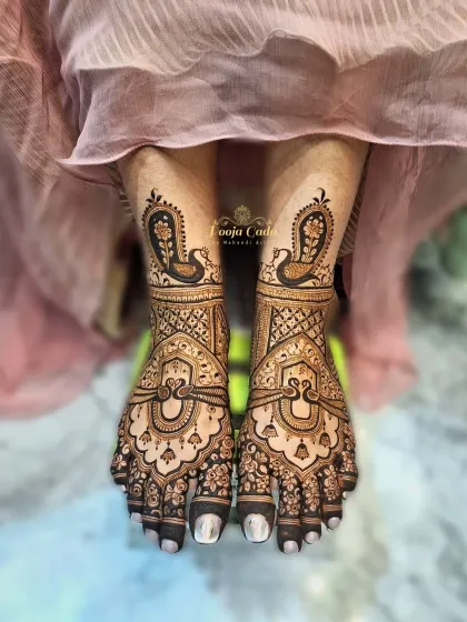 An elegant feet mehendi design with graceful peacock motifs and delicate hanging bells, creating a look of timeless beauty.