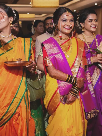 The bridal entry with her squad. The bride stands out with her radiant makeup and traditional attire, looking joyful and ready for her new beginning.