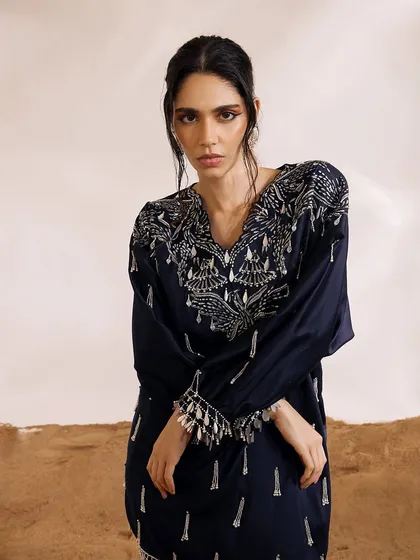 A close-up of the Orion Kaftan Set's neckline, showcasing the detailed phoenix-inspired motifs and delicate pearl work.