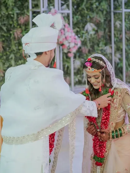 The Varmala ceremony, where the groom places the garland around the bride, a significant ritual in a Maharashtrian wedding.