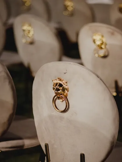 Custom place settings or favors featuring elegant stone slabs with a golden lion head detail. This is an example of the unique, personalized touches we incorporate to make an event truly special.