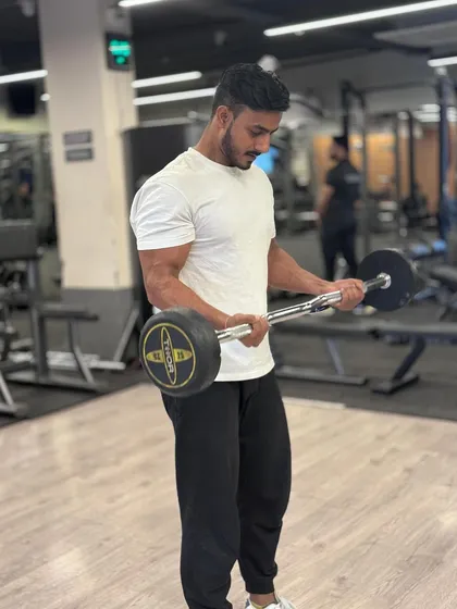 Consistency is what transforms average into excellence. A shot of me during a bicep curl, focusing on building and maintaining my own strength.