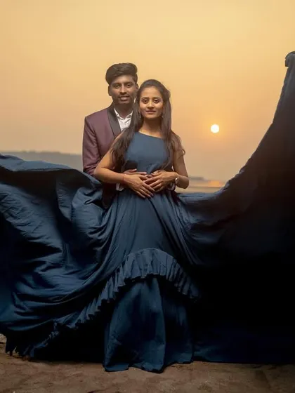 The drama of a flowing gown against a sunset beach creates a truly breathtaking image. This is a perfect example of a glamorous and cinematic beach pre-wedding shoot, ideal for couples wanting that wow-factor.
