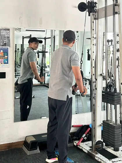 Performing a tricep pushdown at the cable station. This is a go-to exercise for building arm definition and strength.