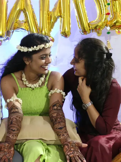 A candid moment of laughter and conversation during a mehndi session. It's an honor to be part of these happy occasions.